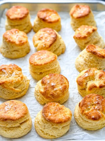 Sheet pan filled with buttermilk biscuits.