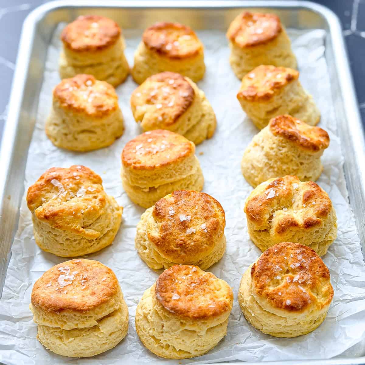 Sheet pan filled with buttermilk biscuits.