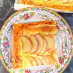 Apple frangipane tart on a floral plate.