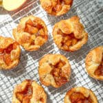 Baked apple croissants on a wire rack.