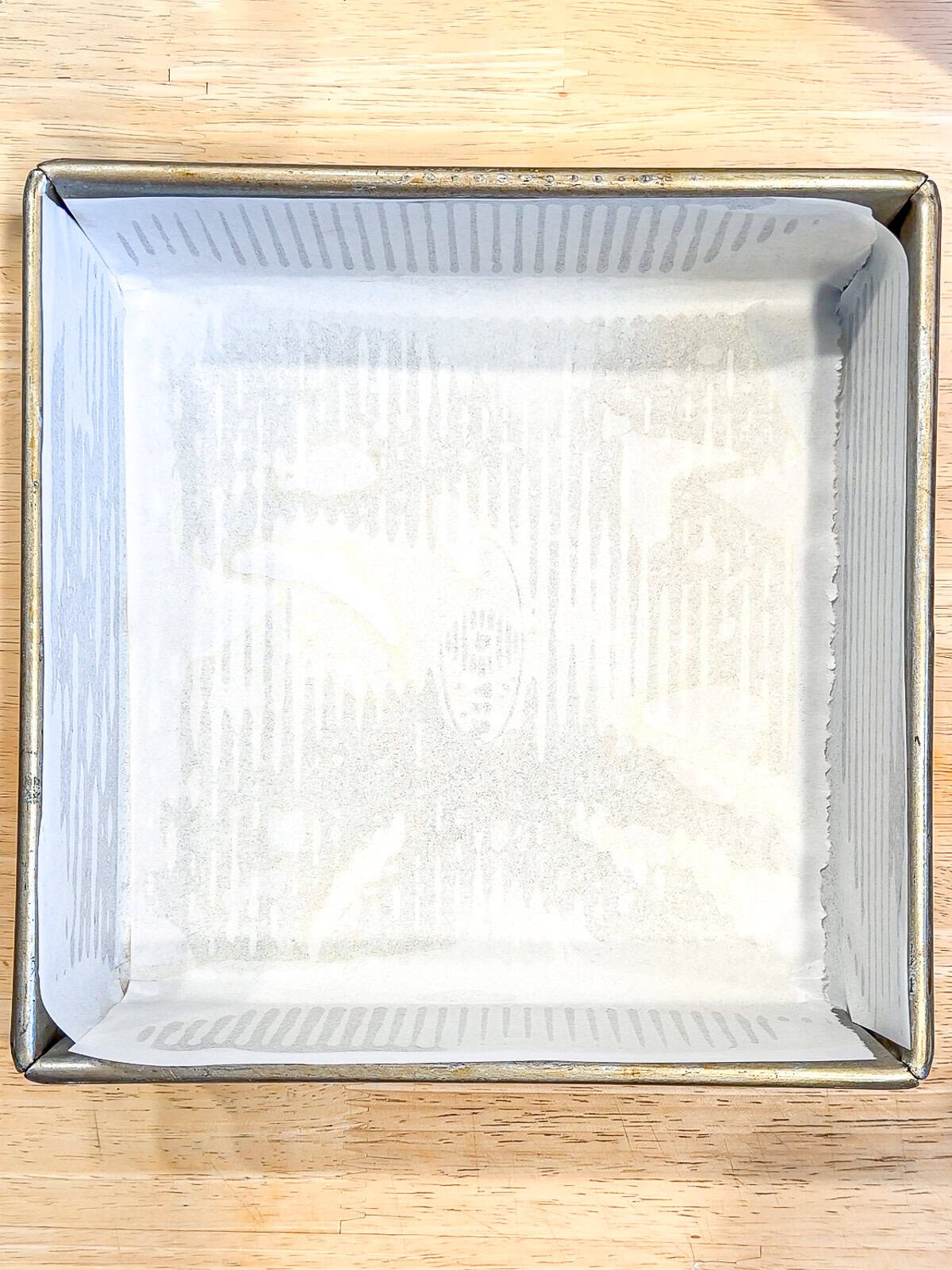 Square pan lined with parchment paper.