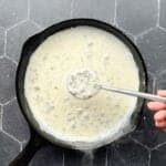 Sausage gravy in a cast-iron pan.