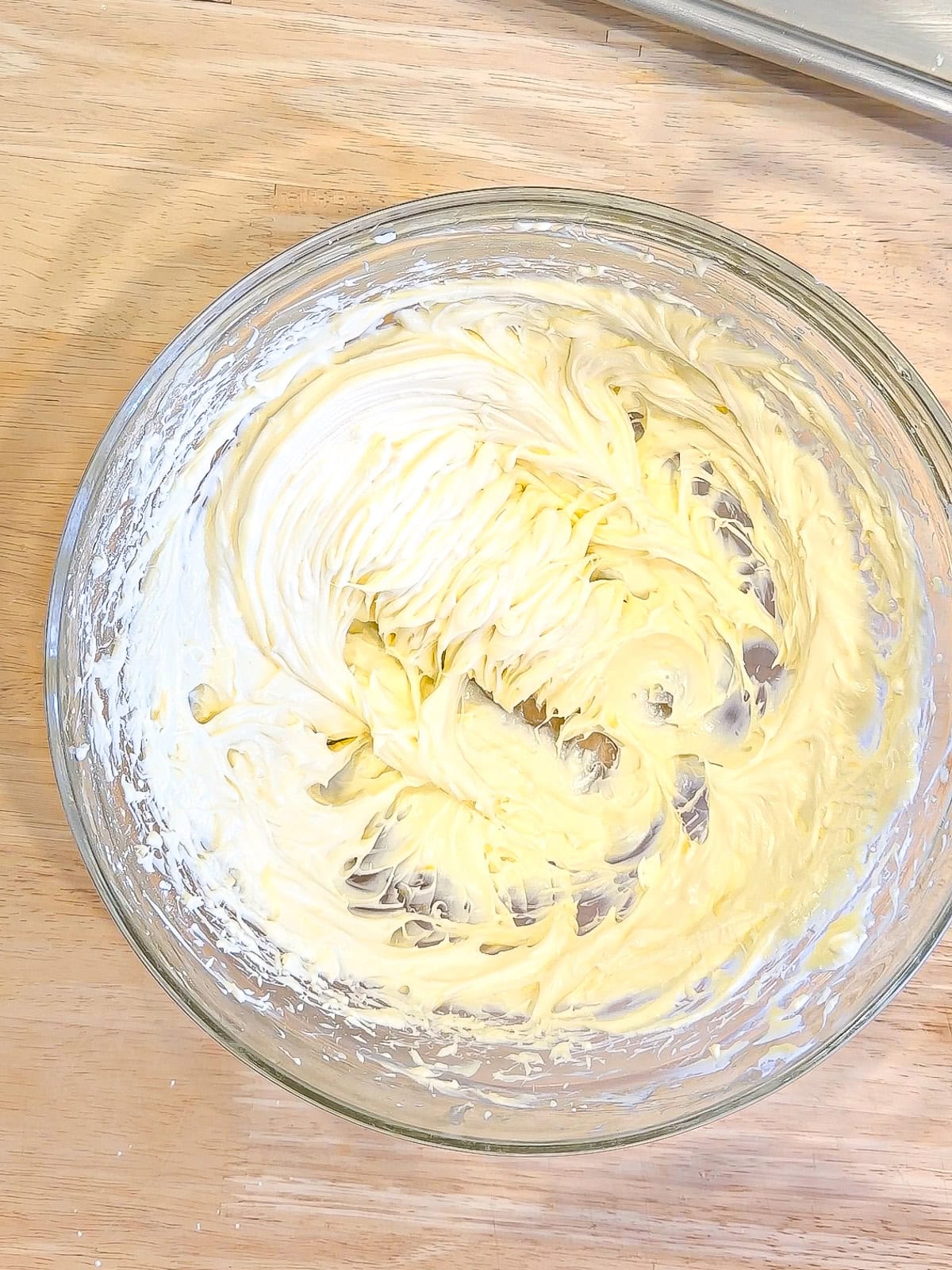 Cheesecake filling in a glass bowl.