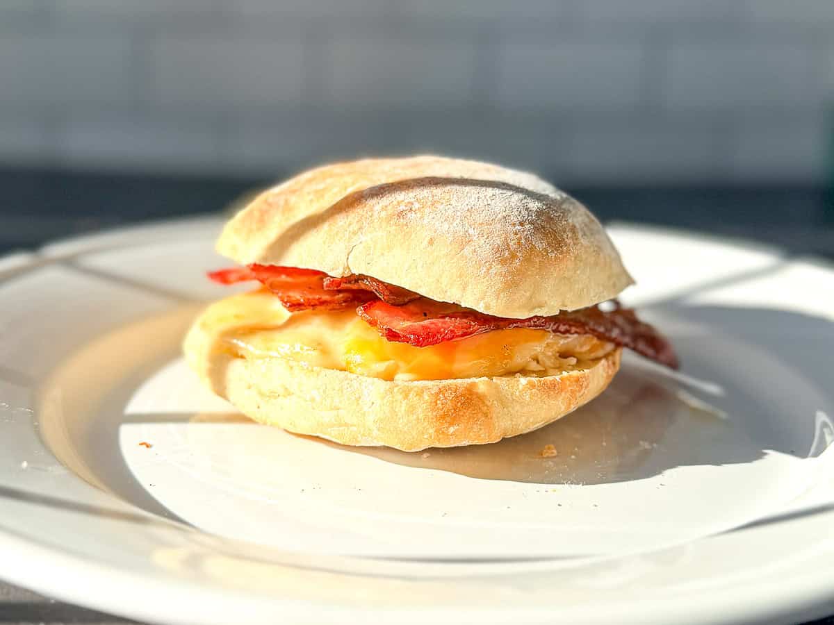 Bacon egg and cheese breakfast sandwich on a toasted ciabatta roll.