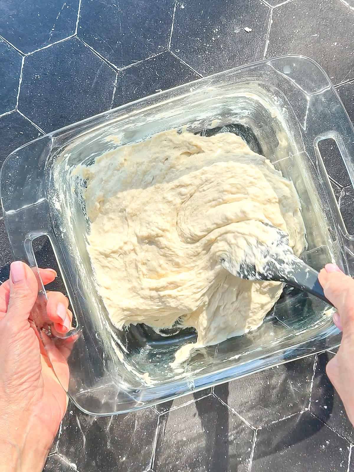 Mixing ingredients to make ciabatta dough.