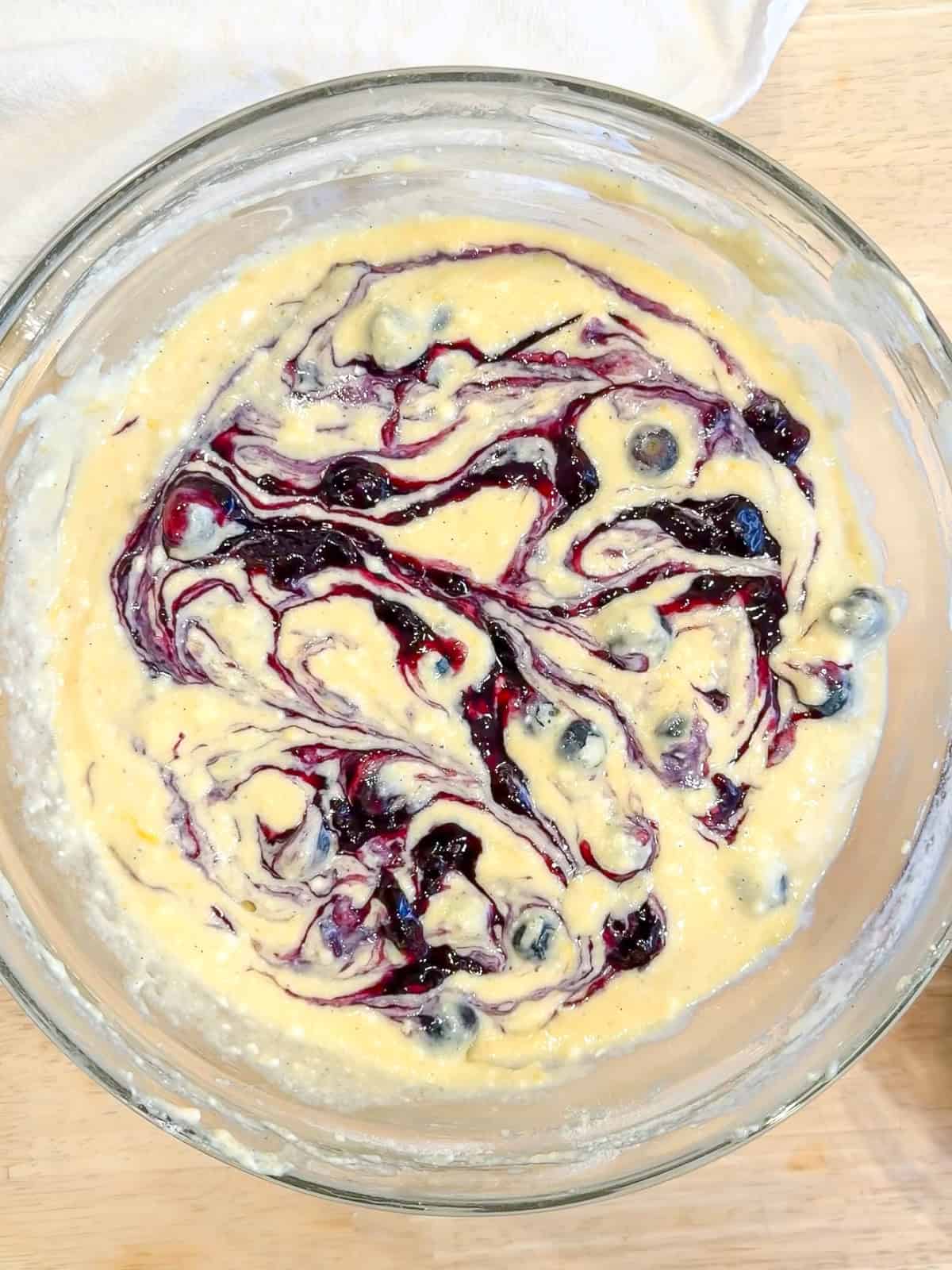 Adding a blueberry jam swirl to lemon ricotta pancake batter.