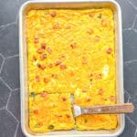 Sheet pan Denver omelette with a wooden spatula.