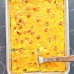 Sheet pan Denver omelette with a wooden spatula.