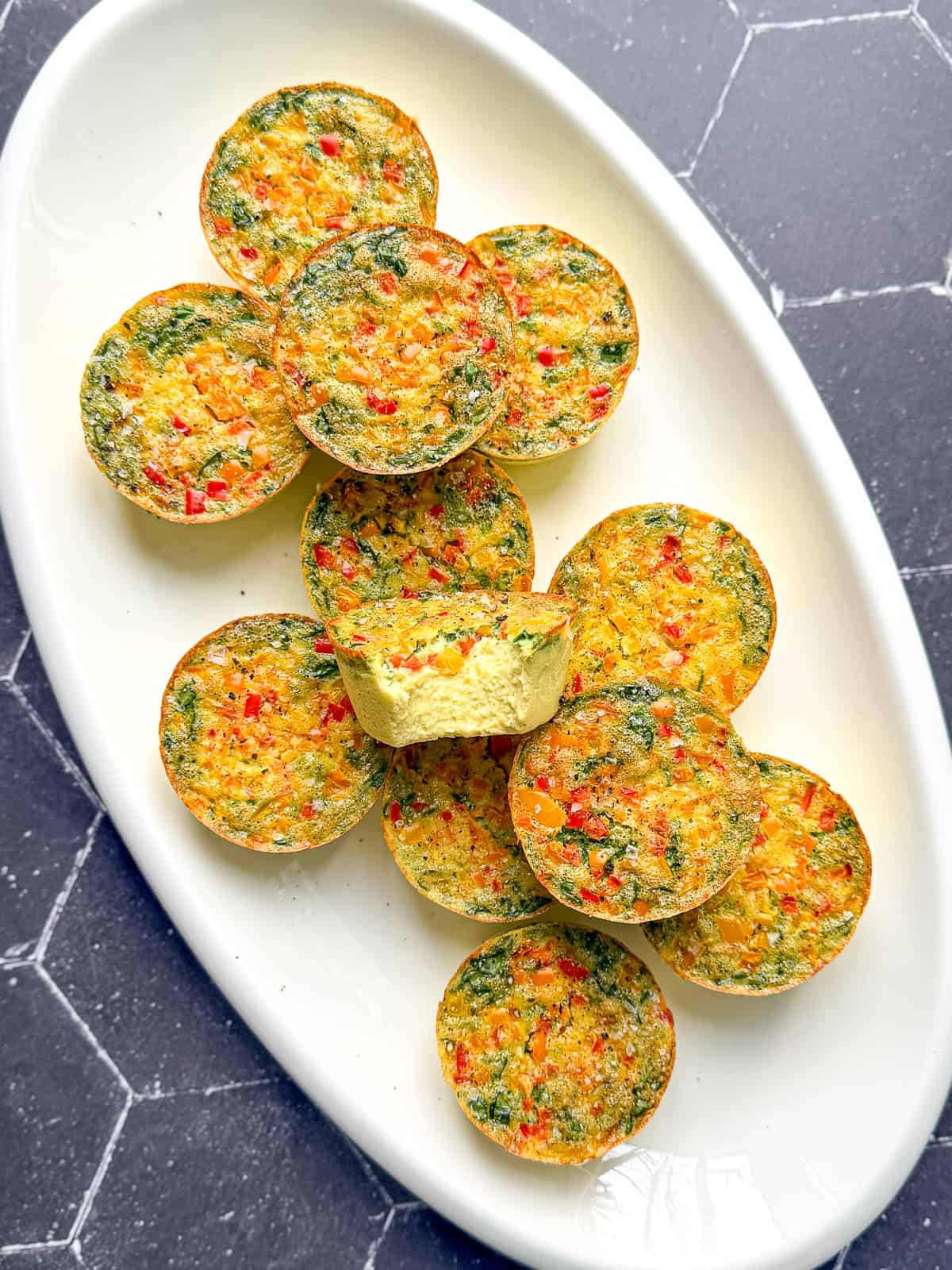 Sous vide egg bites on a white platter.