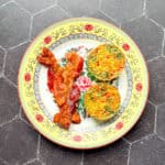 Egg bites and bacon on a yellow floral plate.
