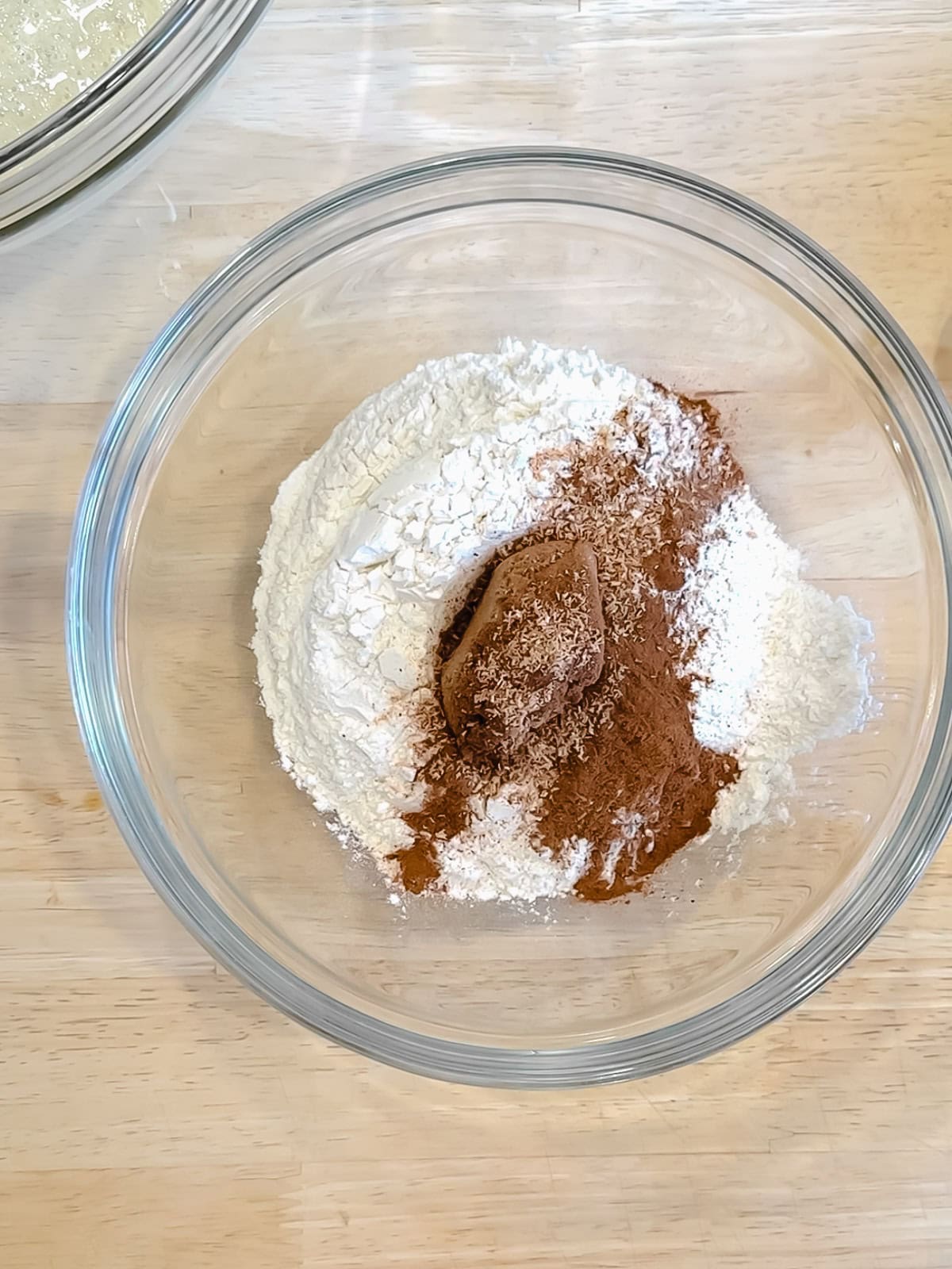 Dry ingredients for a banana waffle waffles in a glass bowl.