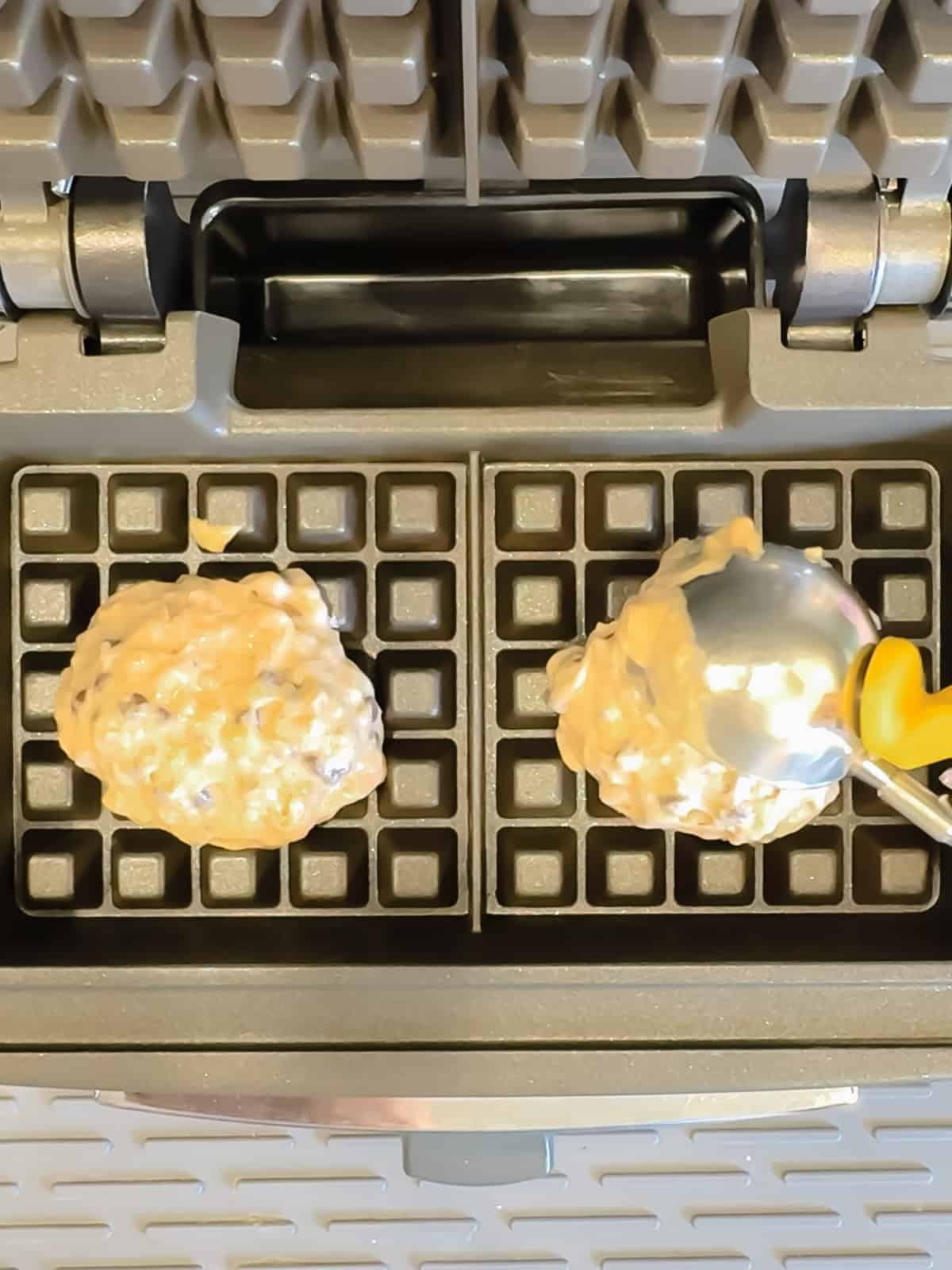 Scooping banana waffle batter into a waffle maker.