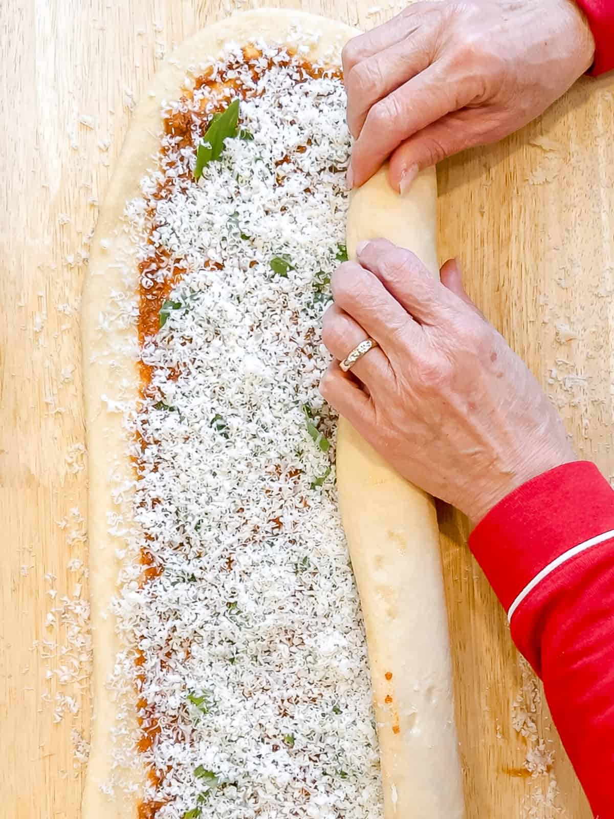 Rolling up a loaf of pane bianco before shaping.