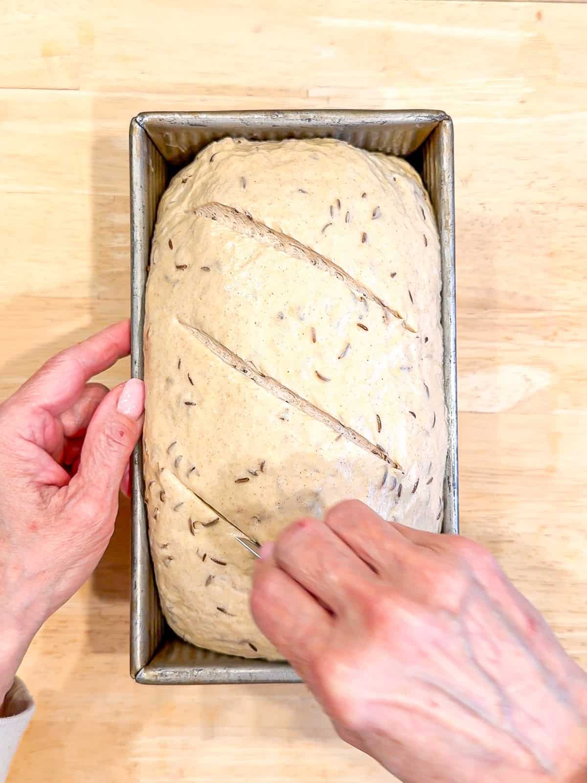 Scoring a loaf of bread.