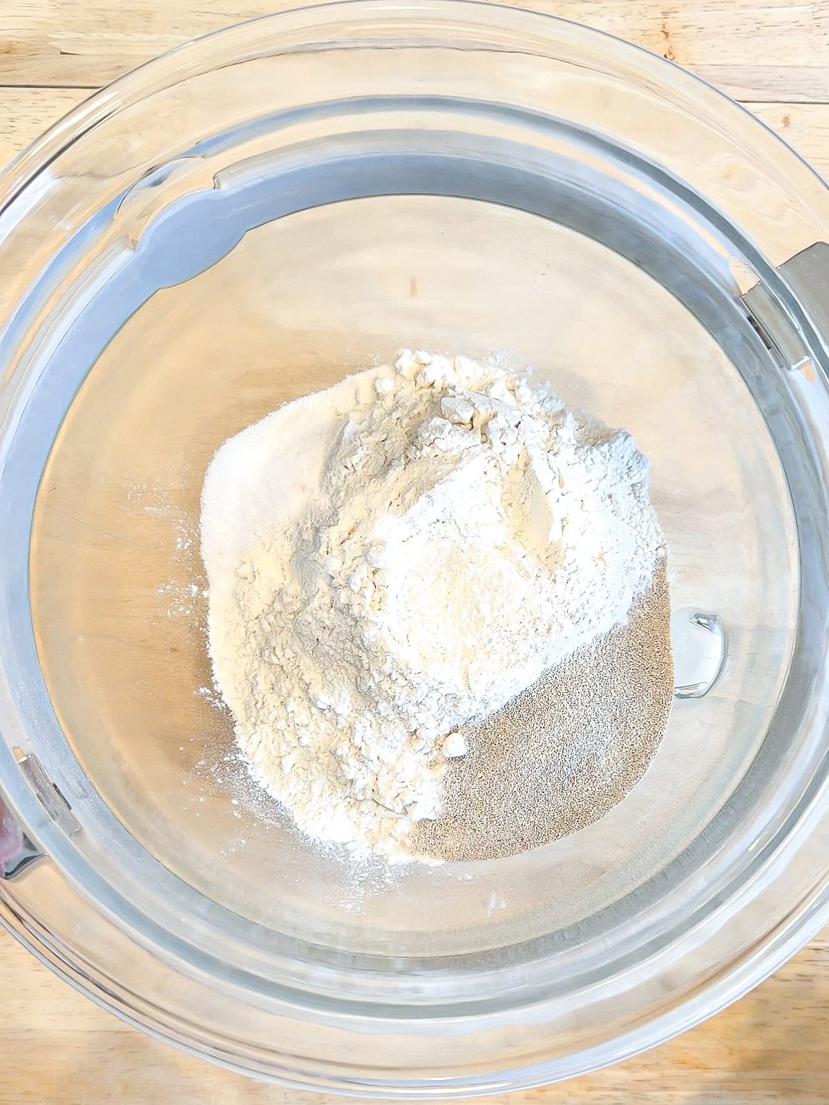 Dry ingredients for crescent rolls in a glass bowl.