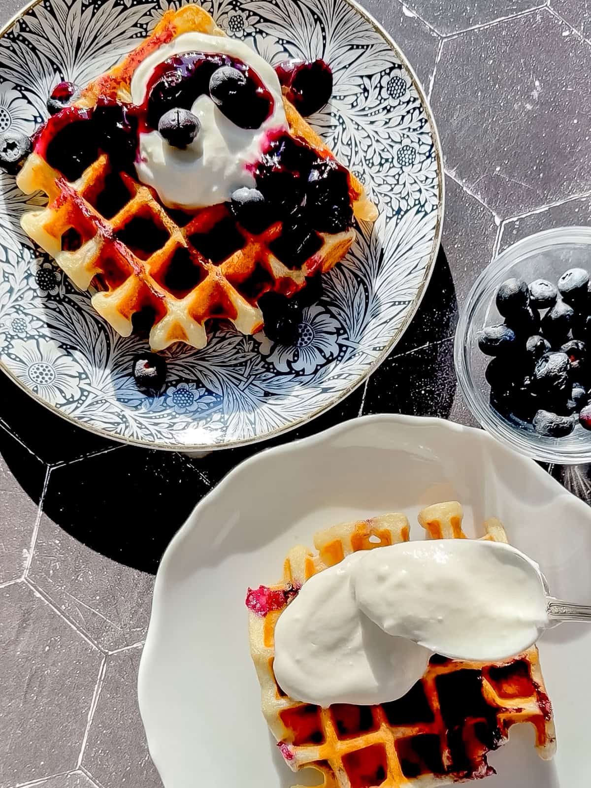 Lemon ricotta waffles on a blue floral plate.