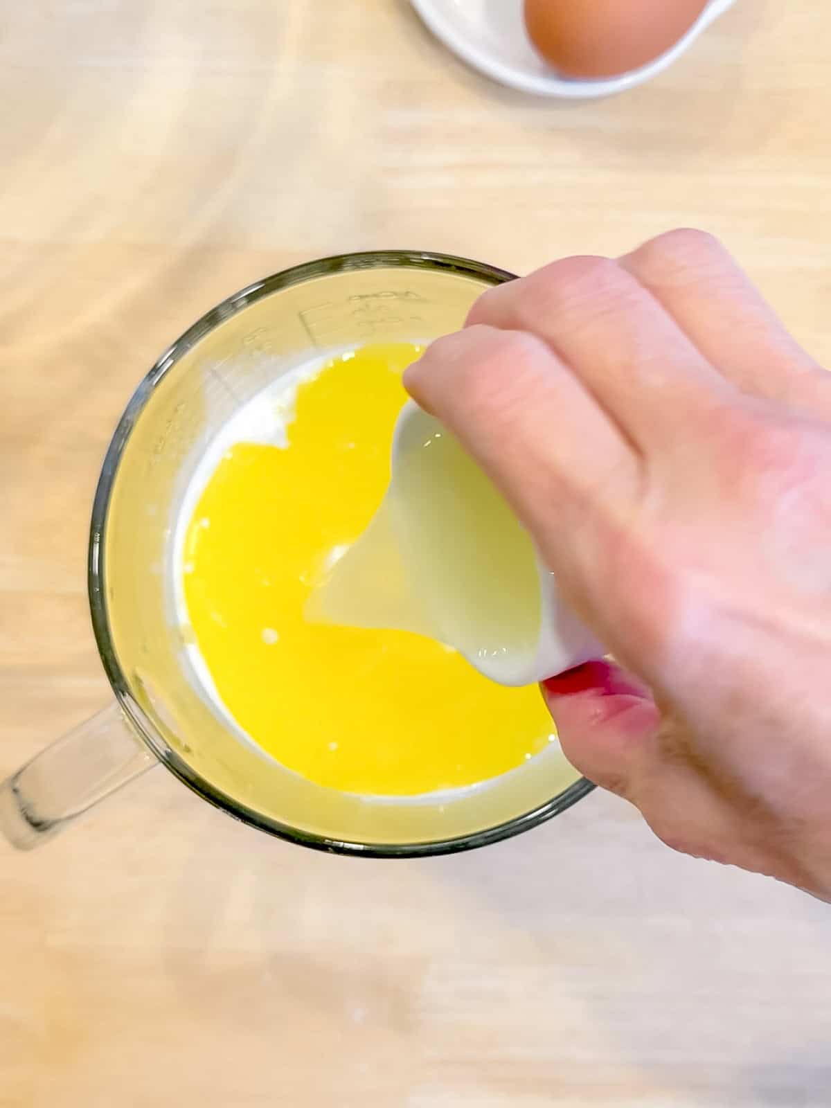Combining wet ingredients in a glass pitcher.