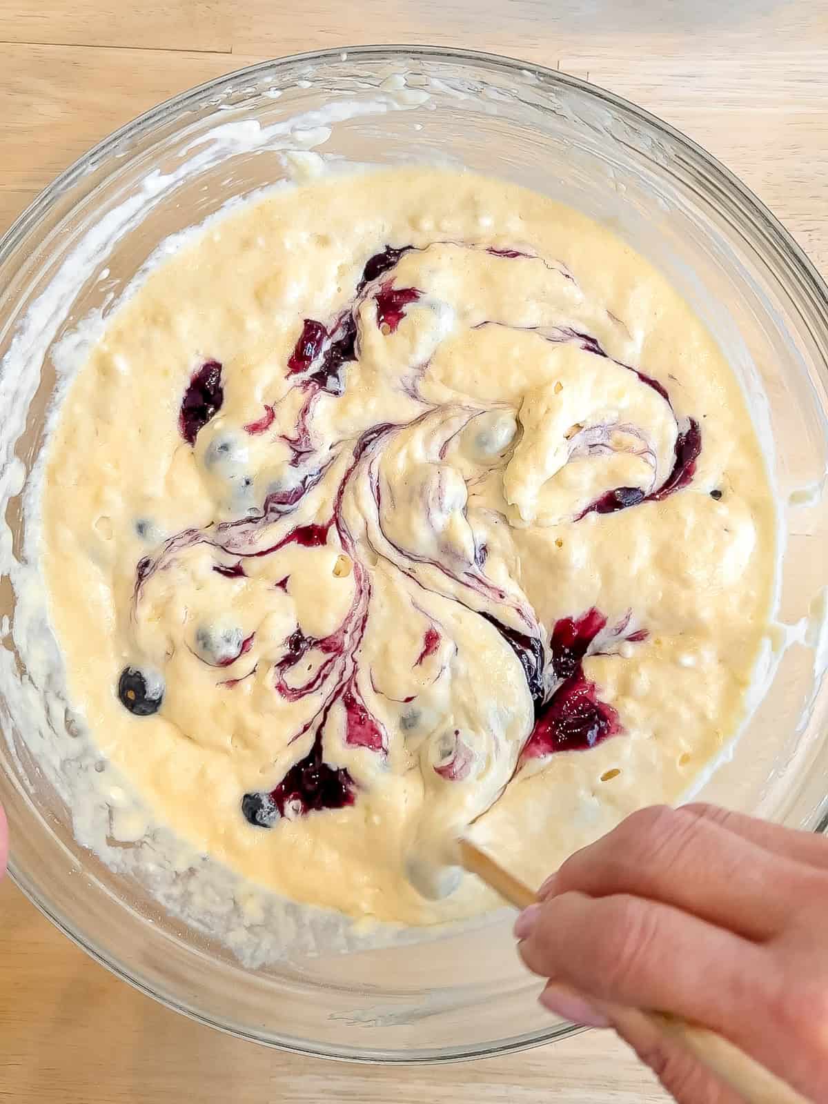 Swirling blueberry jam into waffle batter.