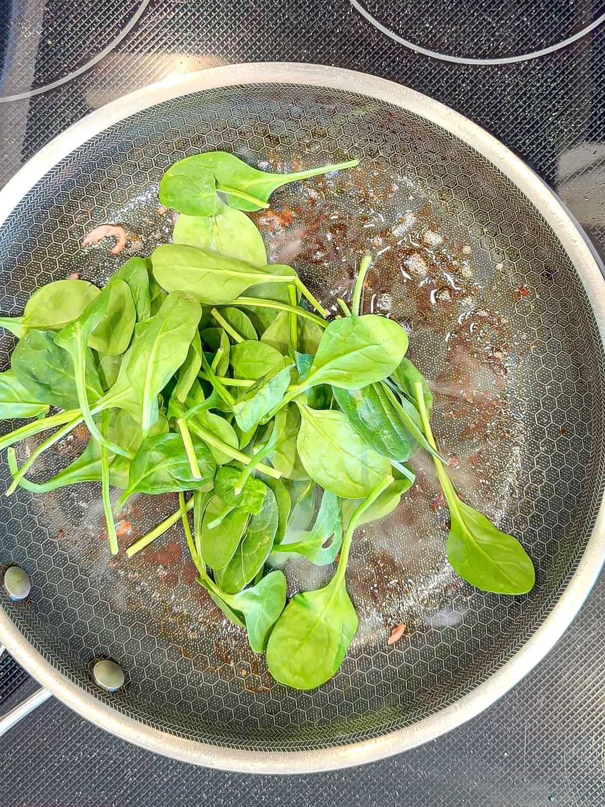 Spinach in a black pan.