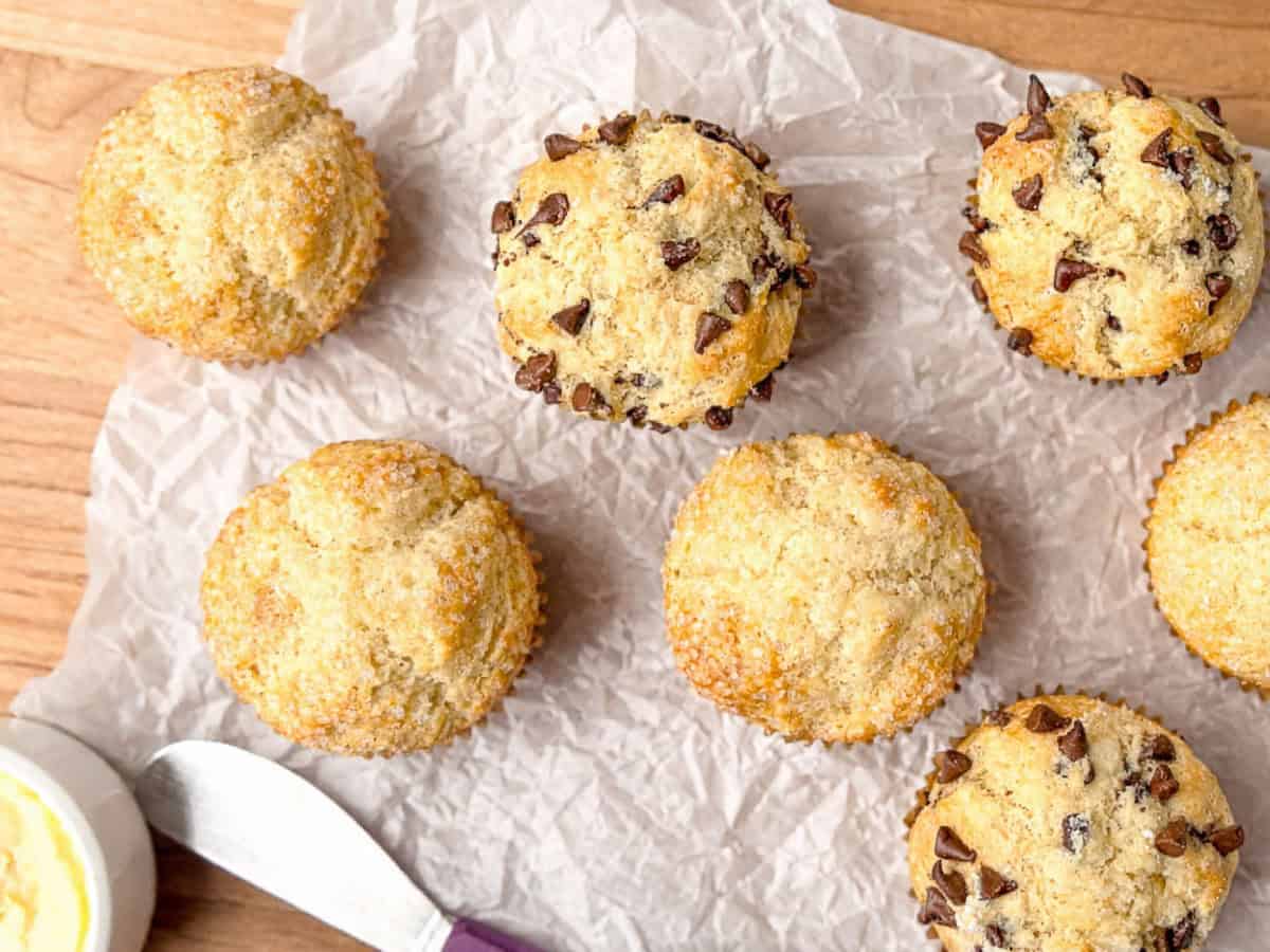Irish soda bread muffins and a crock of salted butter on parchment paper.