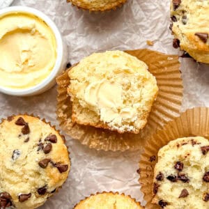 Irish soda bread muffins and a crock of salted butter on parchment paper.
