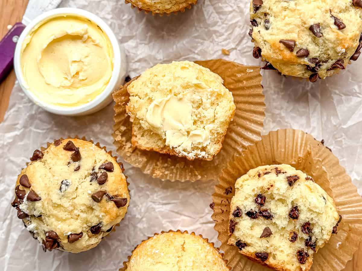 Irish soda bread muffins and a crock of salted butter on parchment paper.