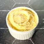 A ramekin filled with whipped salted butter with flaky salt on top.