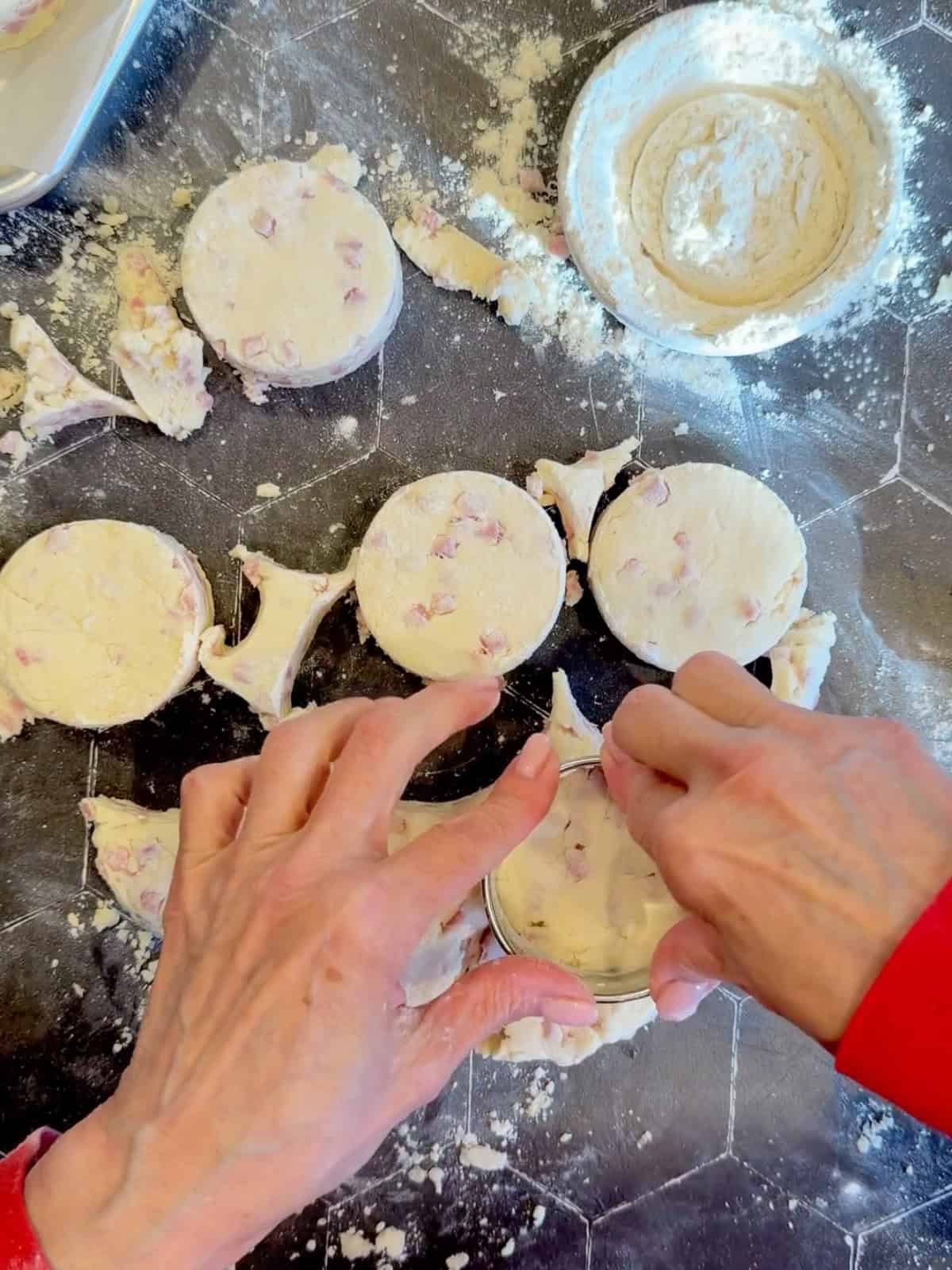 Cutting out biscuits with a round biscuit cutter.