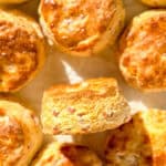 Ham and cheese biscuits on a parchment paper lined sheet pan.