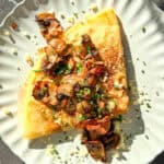 Mushroom crêpe on a ivory plate.