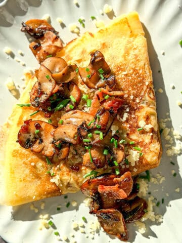 Mushroom crêpe on a ivory plate.