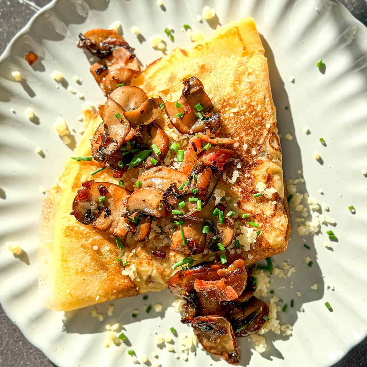 Mushroom crêpe on a ivory plate.