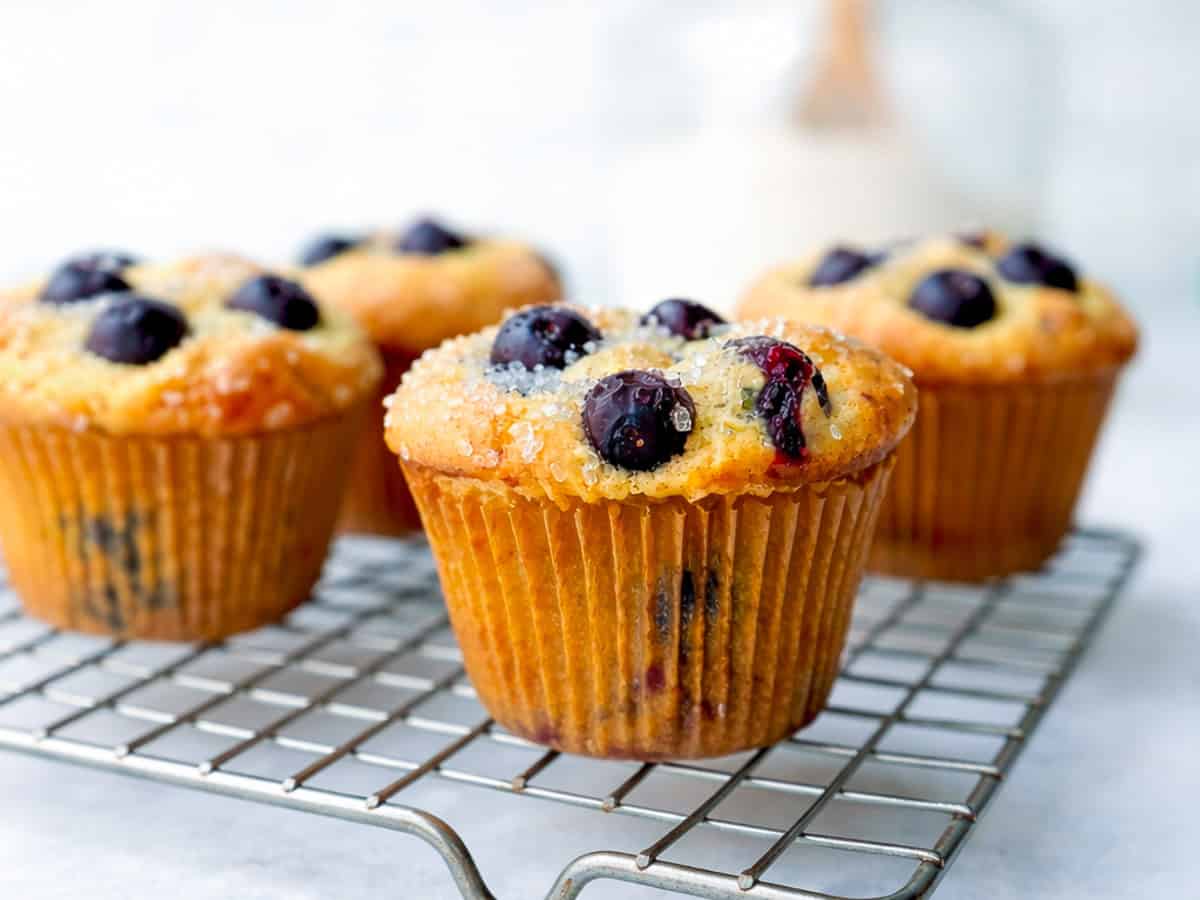 Blueberry pancake muffins on a wire rack.