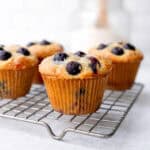 Blueberry pancake muffins on a wire rack.