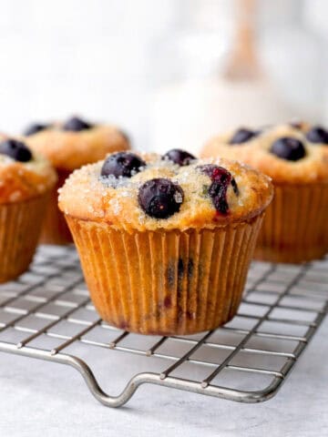 Blueberry pancake muffins on a wire rack.