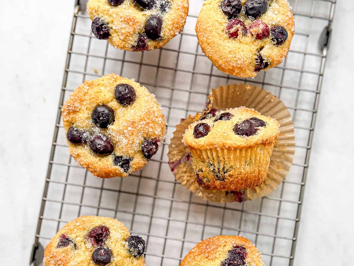 Blueberry pancake muffins on a wire rack.