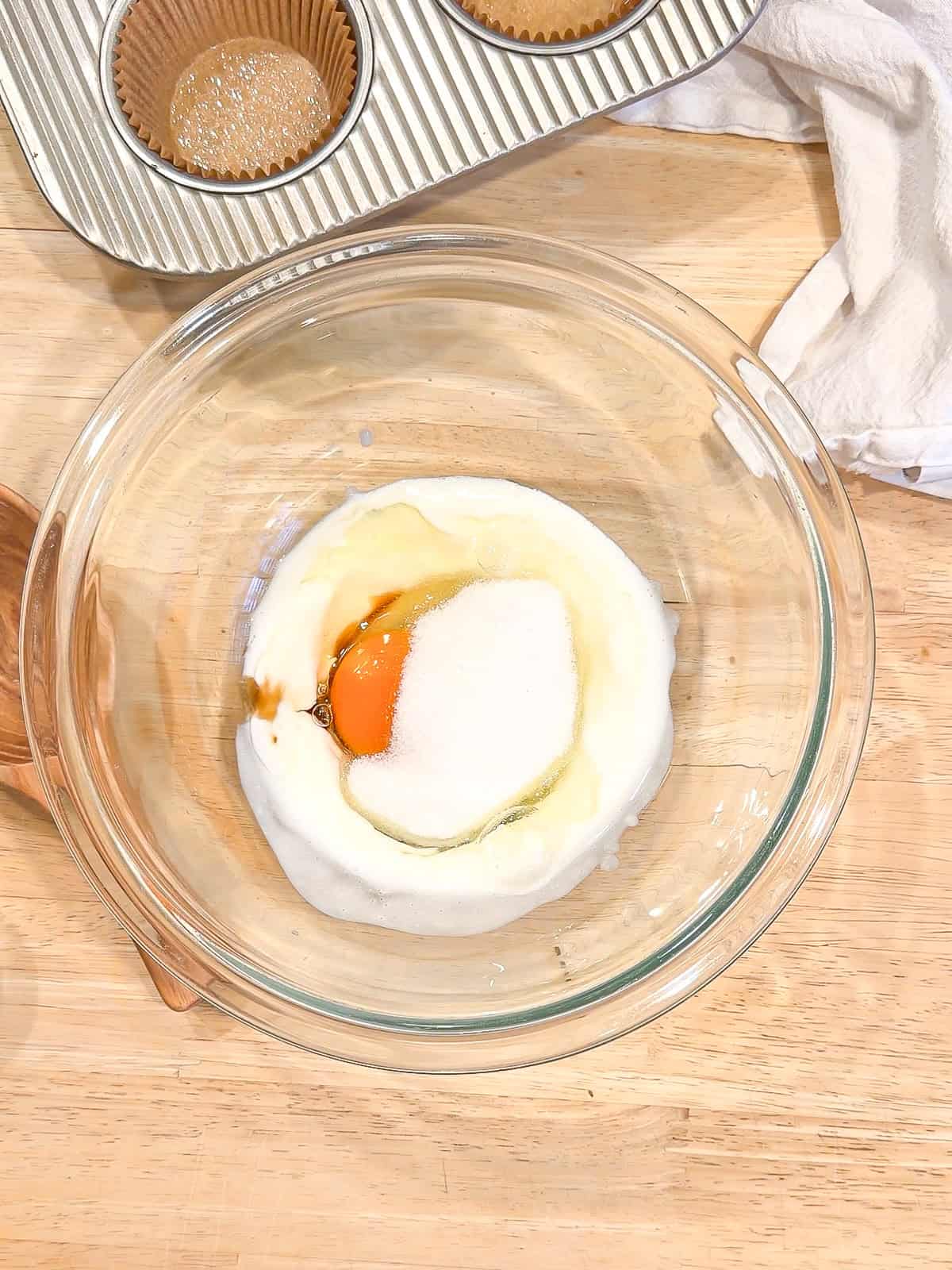 Wet ingredients four muffins in a glass bowl.