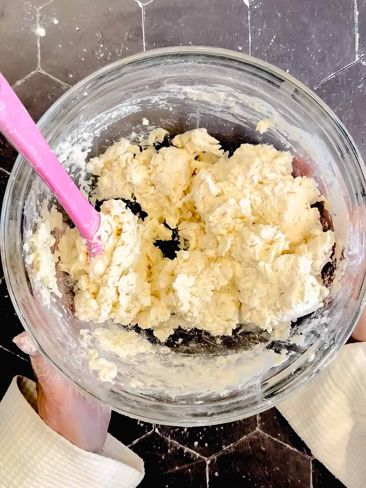 Mixed biscuit dough in a glass bowl.