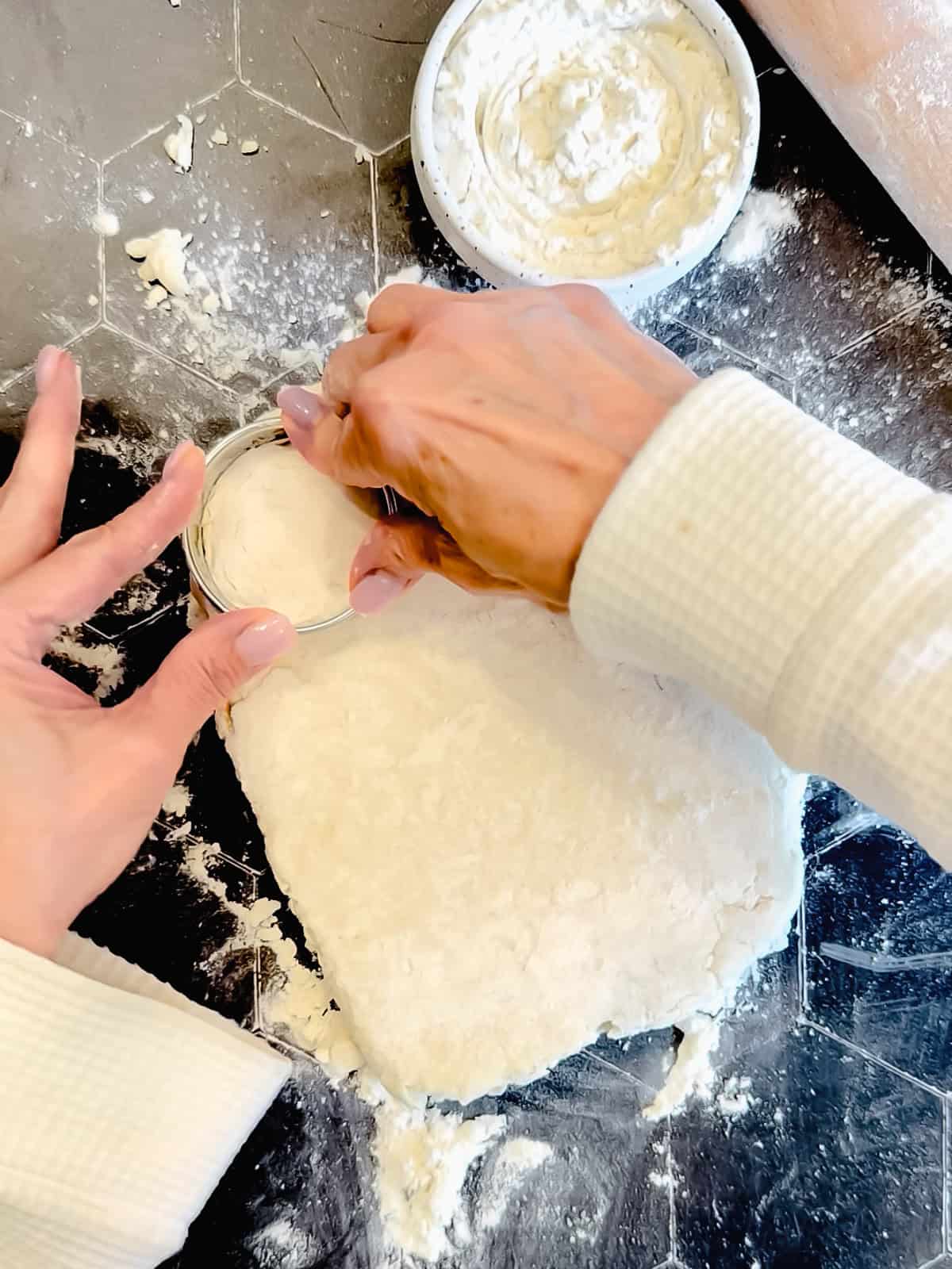 Cutting out a round biscuit from biscuit dough.