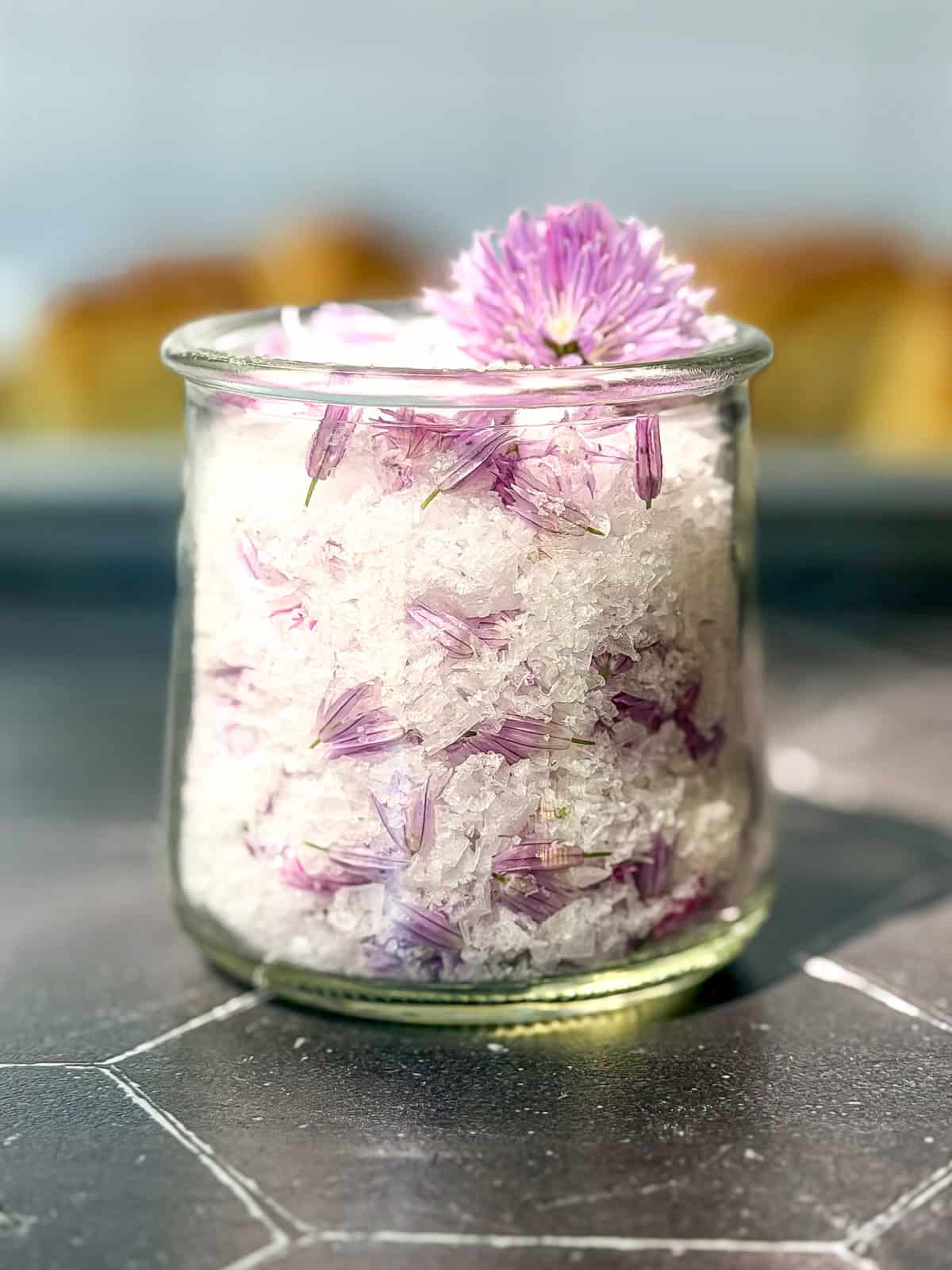 Chive salt in a glass container.