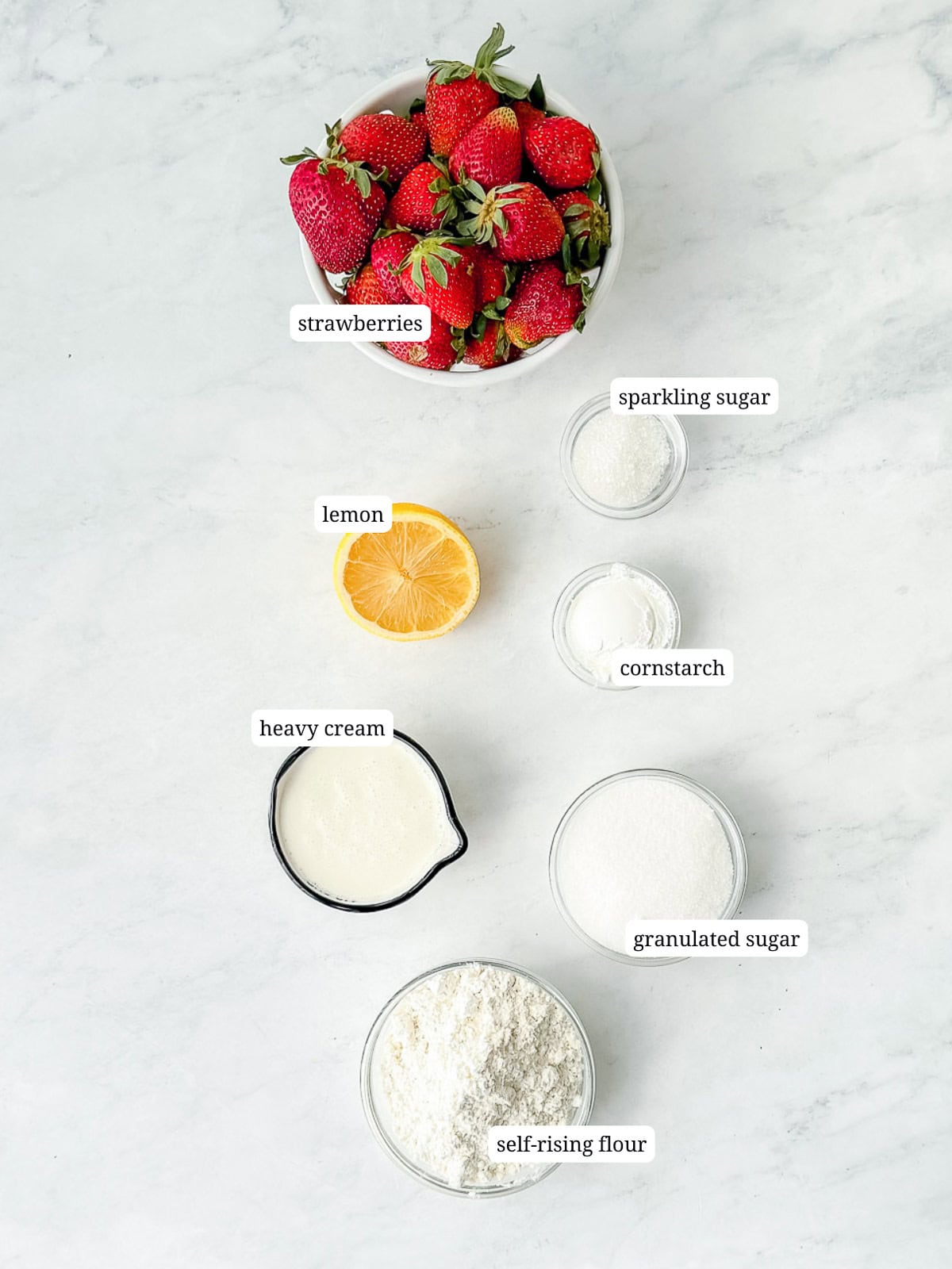 Labeled image of ingredients needed to make biscuit strawberry cobbler.