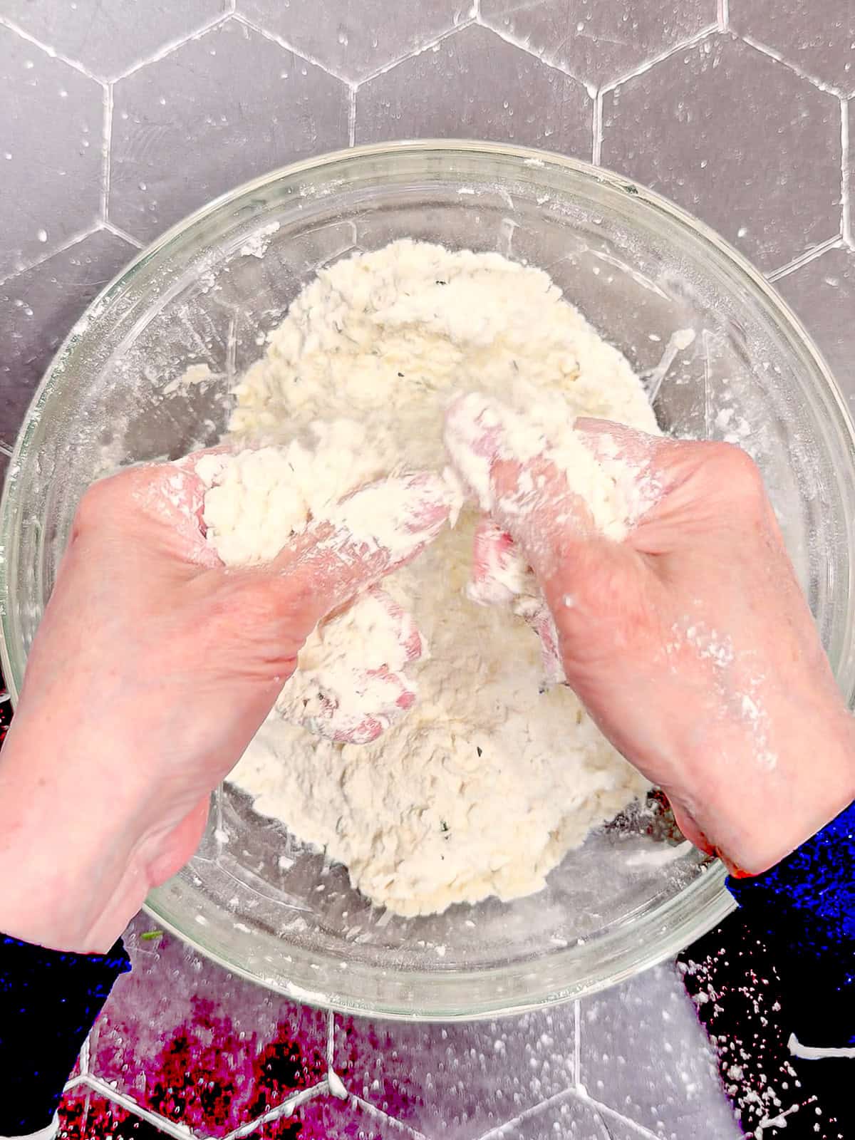 Using fingers to rub butter into dry ingredients for scones.