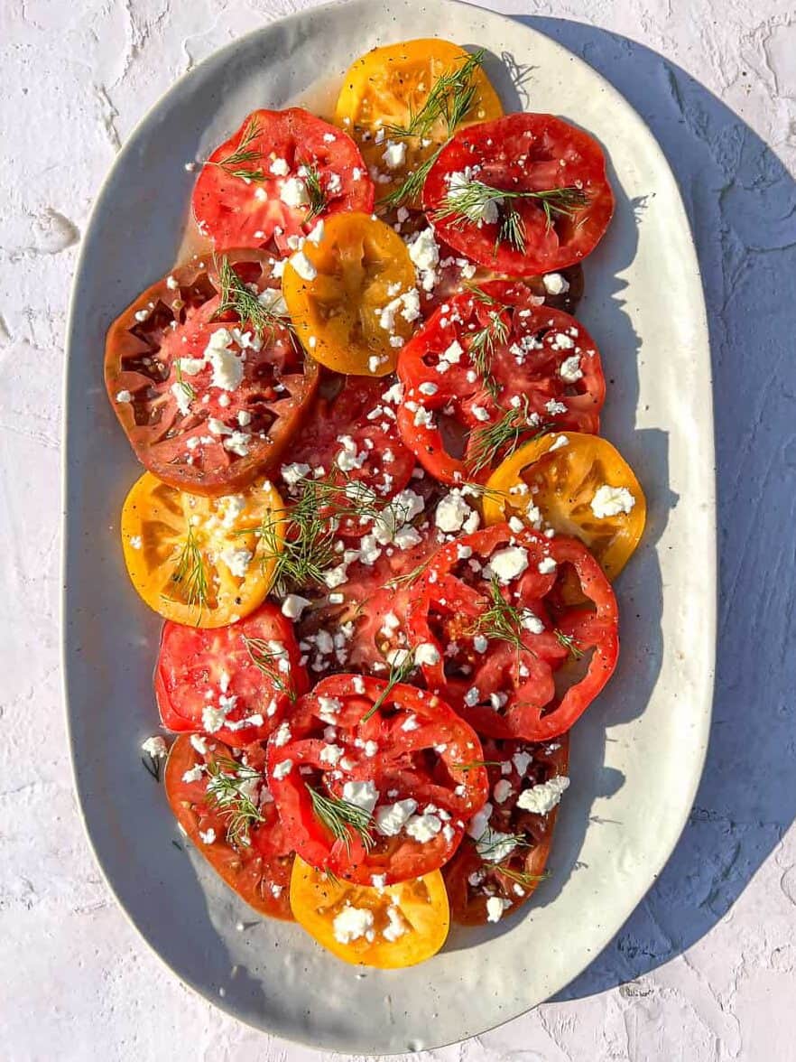 Marinated tomatoes on a grey plate.