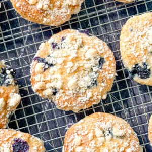 Top view of a blueberry muffin top on a wire rack.