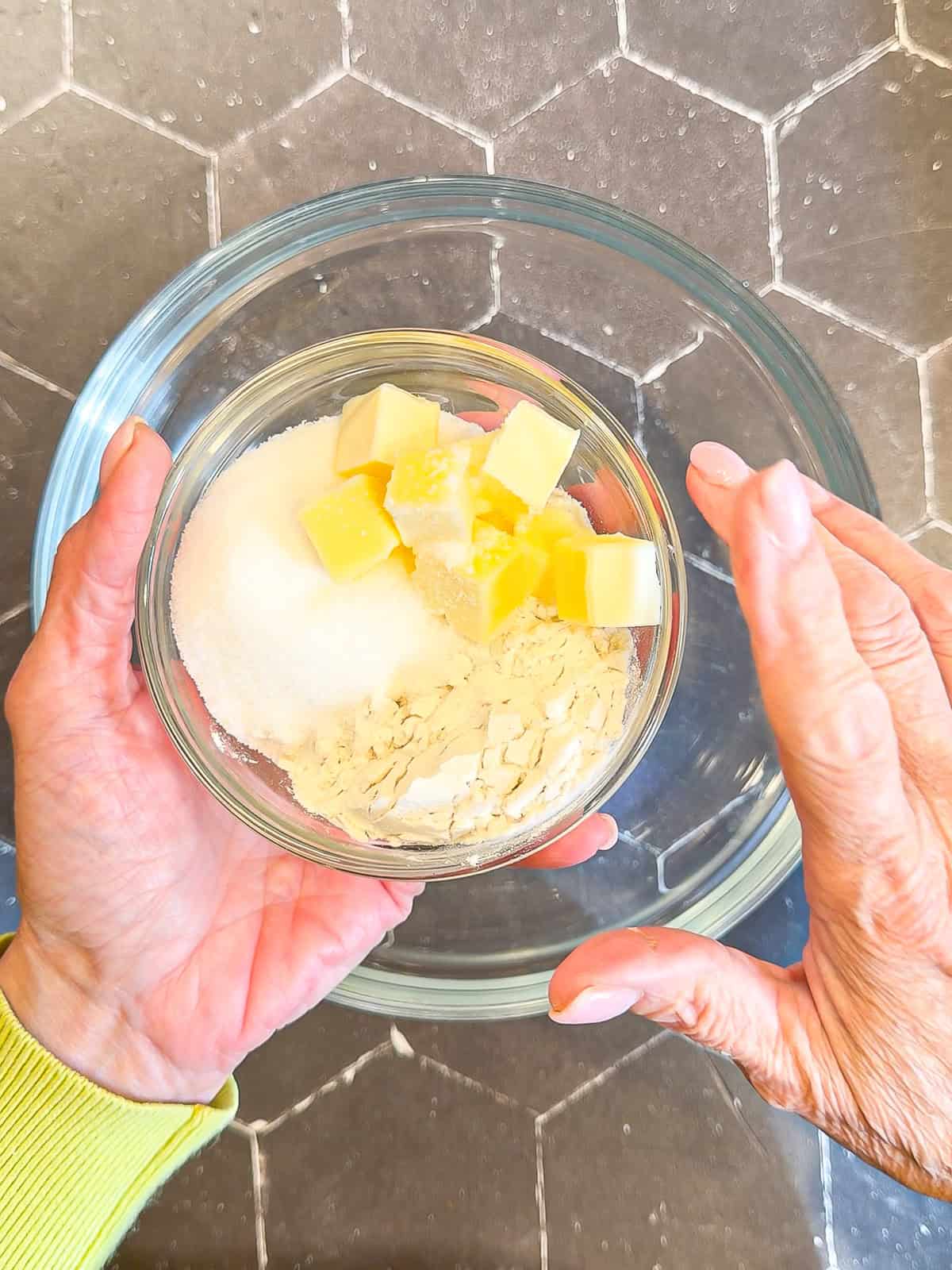 Ingredients to make a crumb topping in a glass bowl.