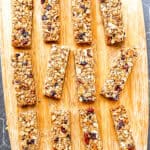Granola bars on a wooden cutting board.