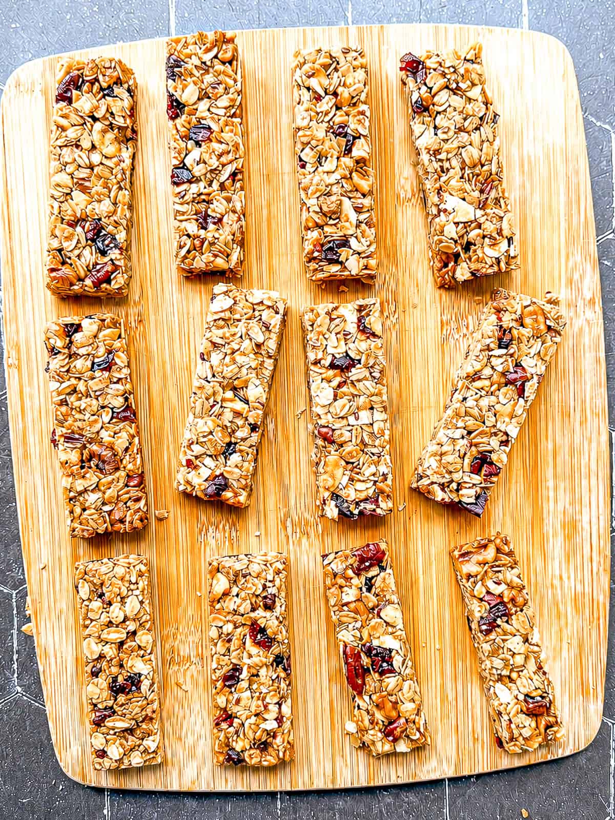 Granola bars on a wooden cutting board.