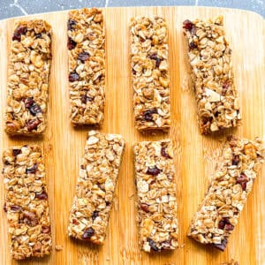 Granola bars on a wooden cutting board.
