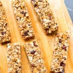 Granola bars on a wooden cutting board.