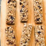 Granola bars on a wooden cutting board.